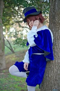 Rating: Safe Score: 0 Tags: 1girl bangs blue_eyes blue_headwear blurry brown_hair capelet fur_trim hat long_sleeves looking_at_viewer outdoors profile short_hair sitting solo souseiseki standing tree white_legwear User: admin