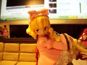 Rating: Safe Score: 0 Tags: 1girl blonde_hair blurry blurry_background blurry_foreground bookshelf bow couch depth_of_field doll dress hair_bow hinaichigo indoors looking_at_viewer pantyhose photo sitting solo window User: admin