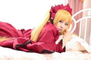 Rating: Safe Score: 0 Tags: 1girl blonde_hair blue_eyes blurry bow depth_of_field dress long_hair looking_at_viewer lying on_stomach red_dress shinku solo twintails User: admin