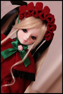 Rating: Safe Score: 0 Tags: 1girl black_border blonde_hair blue_eyes bonnet bow bowtie capelet doll dress flower green_bow letterboxed lips long_hair looking_at_viewer red_dress rose shinku simple_background solo User: admin