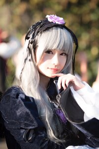 Rating: Safe Score: 0 Tags: 1girl bangs blurry blurry_background closed_mouth depth_of_field dress finger_to_mouth flower hair_ornament hairband lips long_hair long_sleeves looking_at_viewer nail_polish red_eyes solo suigintou upper_body User: admin