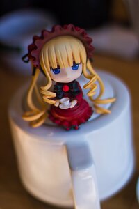 Rating: Safe Score: 0 Tags: 1girl blonde_hair blue_eyes blurry blurry_background blurry_foreground bonnet bow chibi cup depth_of_field doll dress figure flower long_hair long_sleeves looking_at_viewer motion_blur photo red_dress rose saucer shinku solo teacup User: admin
