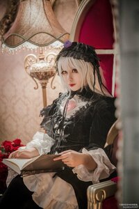 Rating: Safe Score: 0 Tags: 1girl black_dress blurry book depth_of_field dress flower frills gothic_lolita holding lips lolita_fashion long_sleeves red_flower red_rose rose sitting solo suigintou User: admin
