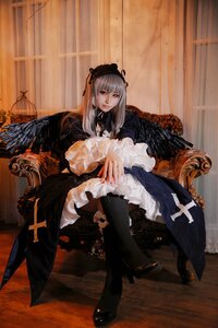 Rating: Safe Score: 0 Tags: 1girl black_wings boots dress frills long_hair long_sleeves looking_at_viewer silver_hair sitting solo suigintou wings User: admin