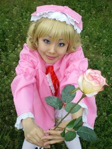 Rating: Safe Score: 0 Tags: 1girl bangs blonde_hair blue_eyes bow capelet dress flower frills hands hat hinaichigo holding_flower long_sleeves looking_at_viewer outdoors pink_dress pink_headwear plant short_hair smile solo upper_body User: admin