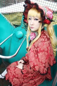 Rating: Safe Score: 0 Tags: 1girl blonde_hair blue_eyes bonnet chain-link_fence dress fence floral_print lips lolita_fashion long_hair looking_at_viewer photo red_dress shinku sitting solo User: admin