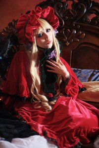 Rating: Safe Score: 0 Tags: 1girl blonde_hair blue_eyes bonnet dress flower frills lips long_hair long_sleeves looking_at_viewer red_dress rose shinku sitting solo User: admin