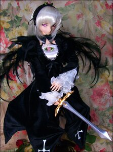 Rating: Safe Score: 0 Tags: 1girl doll dress flower frilled_sleeves frills hairband long_hair silver_hair solo suigintou weapon wings User: admin