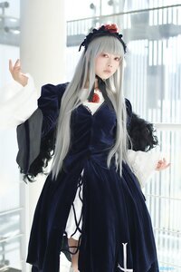Rating: Safe Score: 0 Tags: 1girl bangs blurry blurry_background building depth_of_field dress flower long_hair long_sleeves looking_at_viewer solo standing suigintou User: admin
