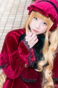 Rating: Safe Score: 0 Tags: 1girl bangs blonde_hair blue_eyes blurry blurry_background bonnet depth_of_field dress drill_hair fence frills lips lolita_fashion long_hair long_sleeves looking_at_viewer red_dress shinku smile solo User: admin