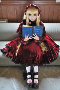 Rating: Safe Score: 0 Tags: 1girl bangs blonde_hair blue_eyes bonnet book dress frills holding lolita_fashion long_hair long_sleeves looking_at_viewer open_book red_dress rose shinku sitting solo User: admin