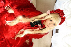 Rating: Safe Score: 0 Tags: 1girl bangs blonde_hair blue_eyes bonnet closed_mouth dress flower frills lips long_hair long_sleeves looking_at_viewer red_dress rose shinku sitting solo User: admin