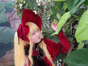 Rating: Safe Score: 0 Tags: 1girl blonde_hair blue_eyes bonnet bow dress flower lips long_hair long_sleeves outdoors realistic red_capelet red_dress rose shinku solo twintails User: admin
