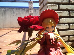 Rating: Safe Score: 0 Tags: 1girl bangs blonde_hair blue_eyes bonnet day doll dress drill_hair flower frills hat long_hair long_sleeves looking_at_viewer outdoors railing red_dress shinku solo standing twintails very_long_hair User: admin