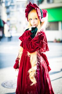 Rating: Safe Score: 0 Tags: 1girl blonde_hair blue_eyes blurry blurry_background blurry_foreground bonnet depth_of_field dress looking_at_viewer outdoors photo red_dress shinku smile solo standing User: admin