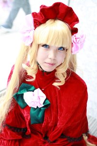 Rating: Safe Score: 0 Tags: 1girl bangs blonde_hair blue_eyes blurry blurry_background bonnet bow depth_of_field dress flower lips long_hair looking_at_viewer red_capelet red_dress rose shinku smile solo User: admin