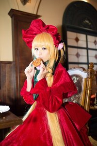 Rating: Safe Score: 0 Tags: 1girl blonde_hair blue_eyes blurry bonnet braid depth_of_field dress flower food indoors long_hair long_sleeves looking_at_viewer red_dress shinku solo table window User: admin