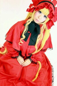 Rating: Safe Score: 0 Tags: 1girl bangs blonde_hair blue_eyes bonnet bow capelet dress frills lips long_hair long_sleeves looking_at_viewer red_dress shinku sitting solo User: admin