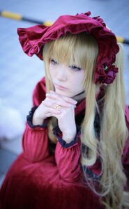 Rating: Safe Score: 0 Tags: 1girl bangs blonde_hair blue_eyes blurry blurry_background blurry_foreground bonnet depth_of_field dress flower hands_together long_hair long_sleeves looking_at_viewer own_hands_together realistic red_dress shinku solo User: admin