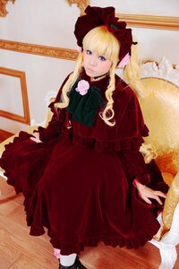 Rating: Safe Score: 0 Tags: 1girl blonde_hair blue_eyes bonnet bow dress flower long_hair long_sleeves looking_at_viewer red_dress rose shinku shoes sitting solo User: admin