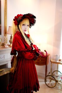 Rating: Safe Score: 0 Tags: 1girl blonde_hair blue_eyes blurry blurry_background bonnet bow capelet checkered_floor depth_of_field dress flower lolita_fashion long_hair looking_at_viewer photo red_dress rose shinku solo standing User: admin