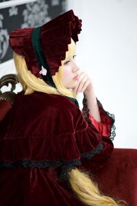 Rating: Safe Score: 0 Tags: 1girl blonde_hair blue_eyes blurry blurry_background bonnet depth_of_field dress frills lace lips lolita_fashion long_hair long_sleeves profile realistic red_dress shinku sitting solo User: admin
