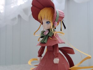 Rating: Safe Score: 0 Tags: 1girl bangs blonde_hair blue_eyes bonnet bow bowtie capelet doll dress green_bow long_hair long_sleeves looking_at_viewer red_dress shinku sidelocks solo standing User: admin