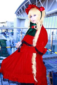 Rating: Safe Score: 0 Tags: 1girl blonde_hair blue_eyes blurry blurry_background bow building capelet depth_of_field dress fur_trim long_sleeves red_capelet red_dress ribbon shinku solo User: admin