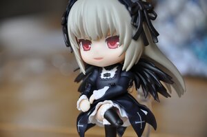 Rating: Safe Score: 0 Tags: 1girl bangs black_wings boots chibi doll dress frills hairband long_hair long_sleeves looking_at_viewer red_eyes ribbon silver_hair sitting solo suigintou wings User: admin