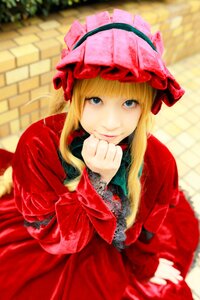 Rating: Safe Score: 0 Tags: 1girl bangs blonde_hair blue_eyes blurry blurry_background bonnet bow depth_of_field dress flower hat long_hair long_sleeves looking_at_viewer red_dress rose shinku sitting smile solo User: admin