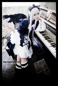 Rating: Safe Score: 0 Tags: 1girl black_border black_wings dress feathers frills instrument letterboxed long_hair pillarboxed silver_hair solo suigintou wings User: admin