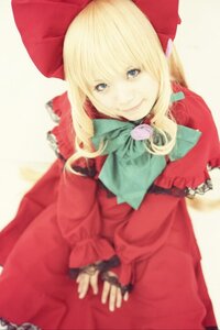 Rating: Safe Score: 0 Tags: 1girl blonde_hair blue_eyes blurry bow depth_of_field dress long_hair long_sleeves looking_at_viewer red_dress shinku smile solo User: admin