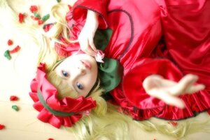 Rating: Safe Score: 0 Tags: 1girl blonde_hair blue_eyes blurry blurry_foreground depth_of_field dress flower foreshortening hands lips long_hair long_sleeves looking_at_viewer lying on_back outstretched_arm red_dress rose shinku solo User: admin
