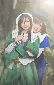 Rating: Safe Score: 0 Tags: 2girls black_hair blurry brown_hair capelet depth_of_field dress green_dress hat long_hair long_sleeves multiple_cosplay multiple_girls smile suiseiseki tagme top_hat User: admin