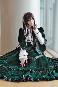 Rating: Safe Score: 0 Tags: 1girl blurry brown_hair closed_mouth depth_of_field dress frills green_dress long_hair long_sleeves looking_at_viewer sitting solo suiseiseki User: admin