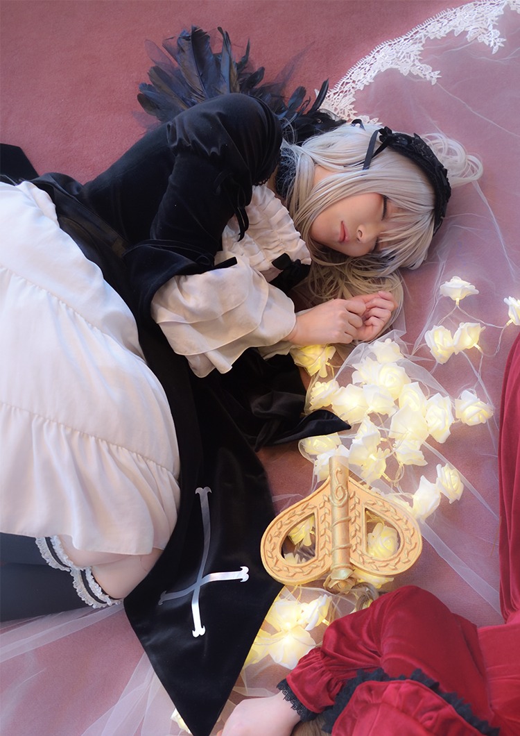 1girl black_legwear closed_eyes doll_joints dress feathers flower gothic_lolita hairband joints lace lips lolita_fashion long_sleeves lying on_side ribbon sleeping solo suigintou