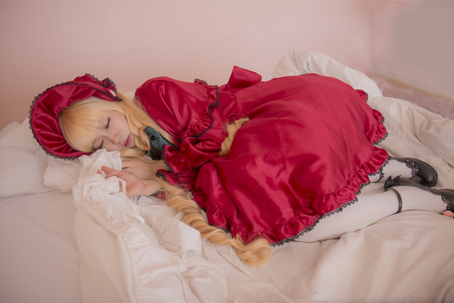 1girl blonde_hair bonnet bow closed_eyes dress lolita_fashion long_hair long_sleeves lying on_side pillow red_dress shinku shoes sleeping solo