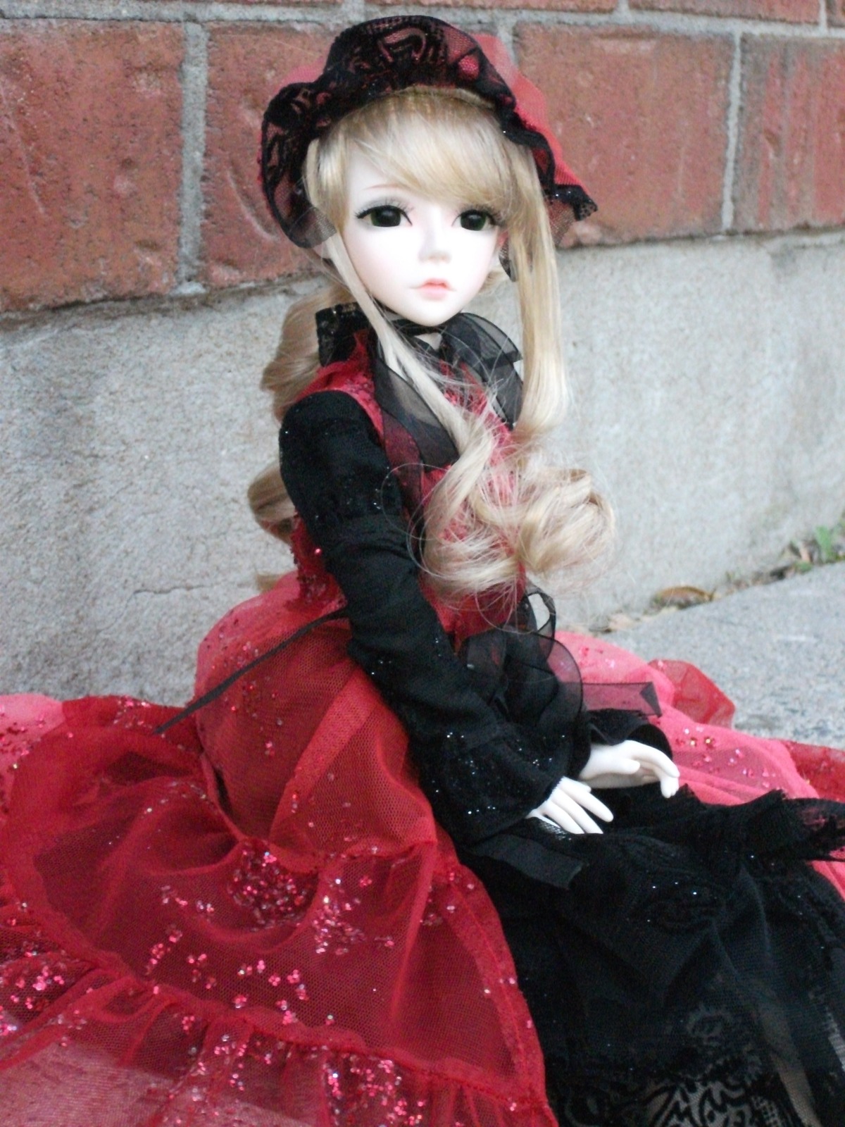 1girl black_dress blonde_hair bonnet doll dress expressionless hat long_hair long_sleeves looking_at_viewer photo red_dress shinku sitting solo traditional_media