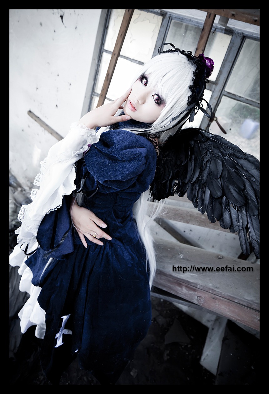 1girl black_border black_wings dress feathered_wings feathers frills hairband letterboxed lips long_sleeves looking_at_viewer solo suigintou white_hair wings