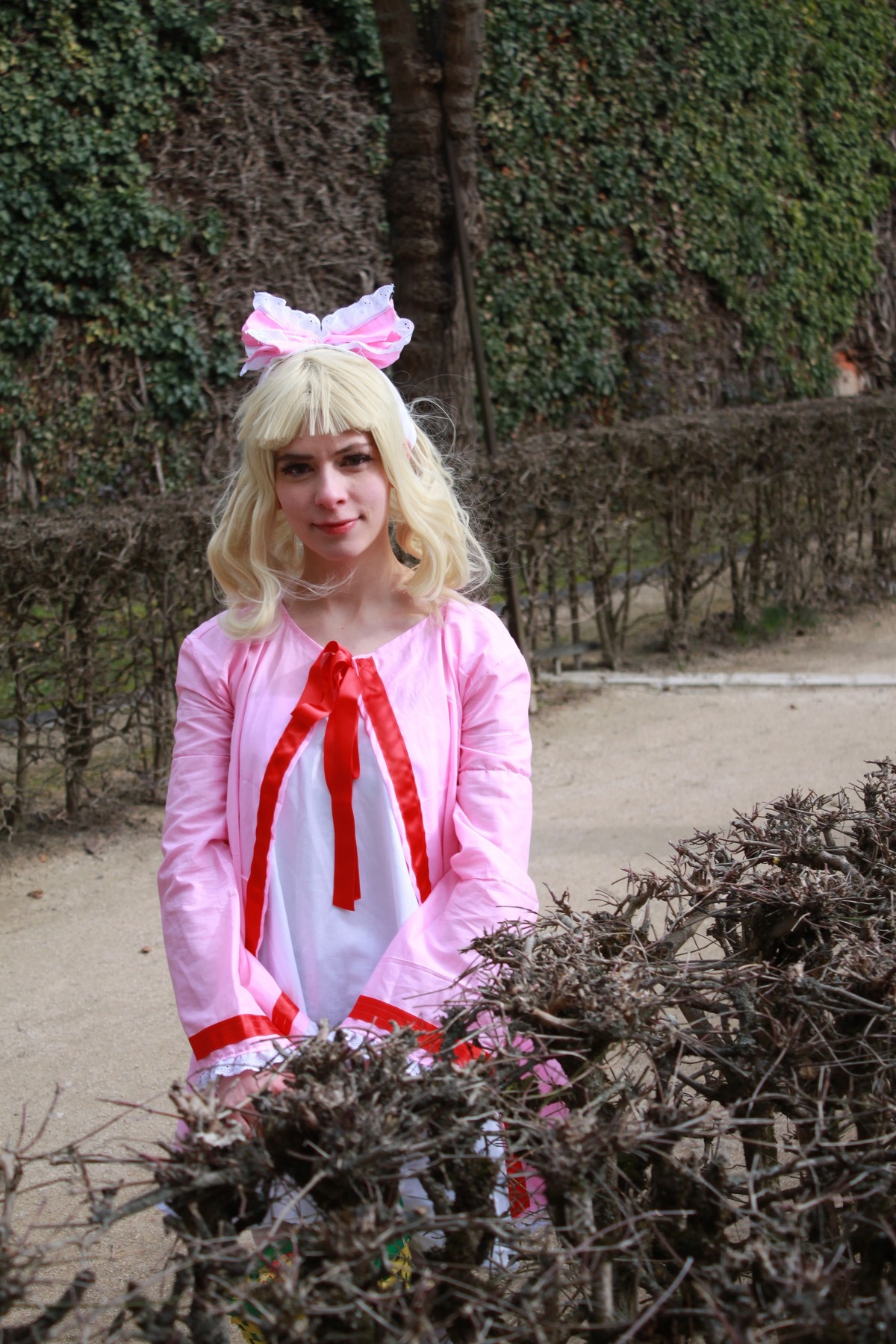 1girl blonde_hair bow hair_bow hinaichigo lips looking_at_viewer nose outdoors plant realistic ribbon shirt solo