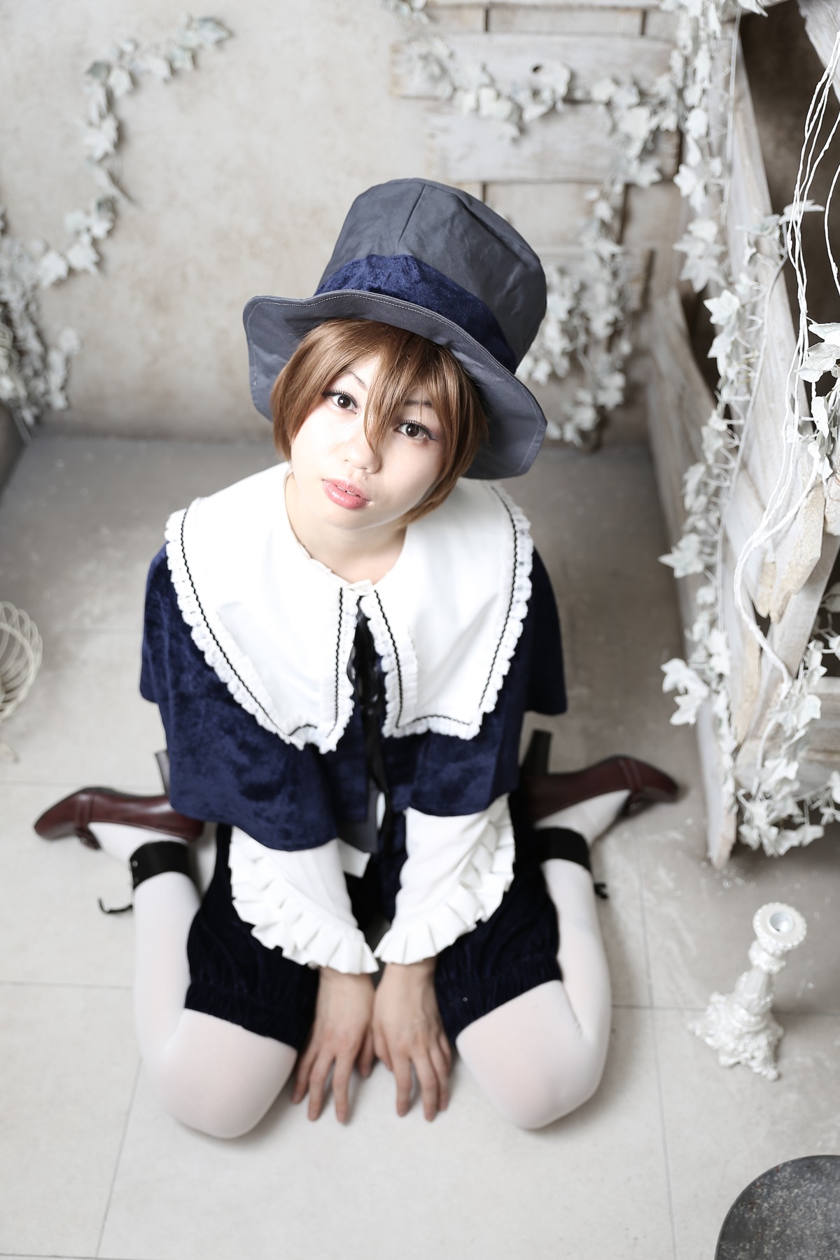 1girl brown_hair dress hat lips realistic short_hair sitting solo souseiseki white_legwear