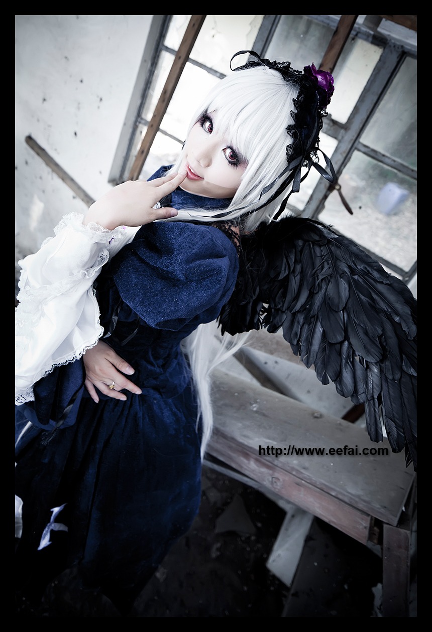 1girl black_border black_wings dress feathered_wings feathers frills gothic_lolita hairband jewelry letterboxed lips long_sleeves looking_at_viewer ring solo suigintou white_hair wings