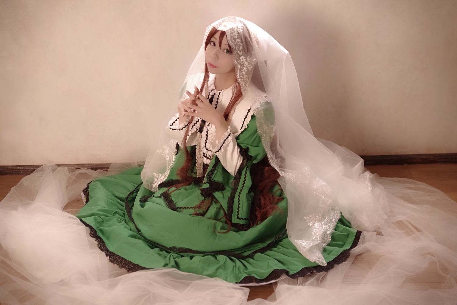 1girl brown_hair dress green_dress green_eyes long_hair long_sleeves sitting solo suiseiseki veil