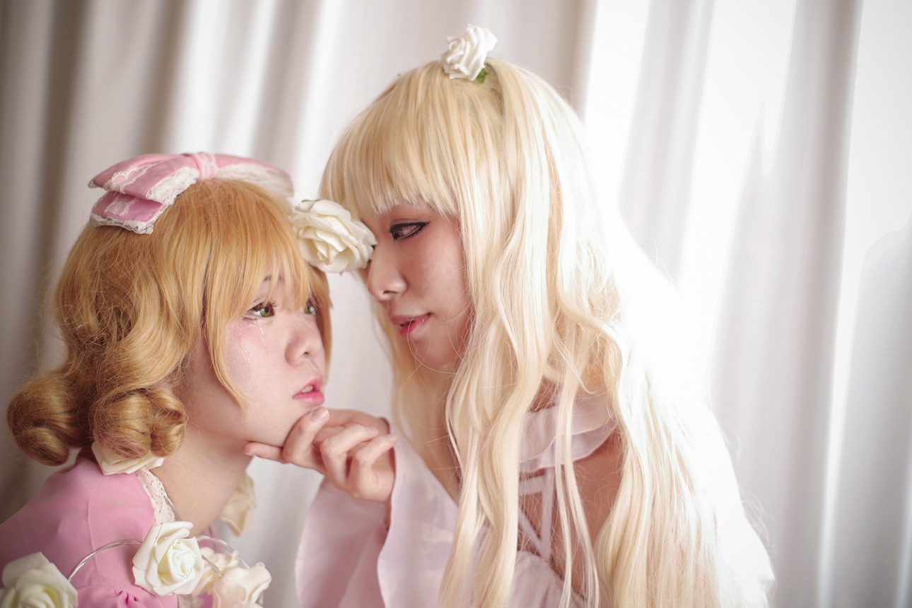 blonde_hair crown curtains eye_contact flower hand_on_another's_chin lips long_hair looking_at_another multiple_cosplay profile realistic rose tagme white_flower white_rose