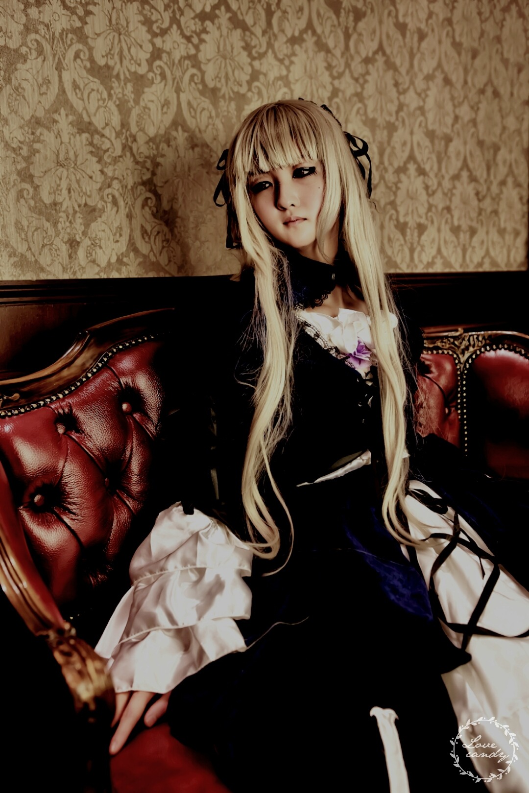 1girl blonde_hair dress gothic hair_ribbon long_hair long_sleeves looking_at_viewer ribbon sitting solo suigintou very_long_hair