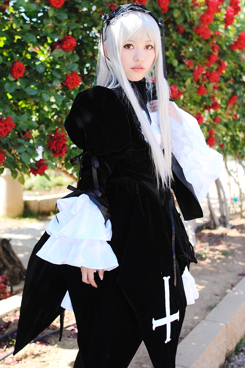 1girl bangs black_dress blurry blurry_background depth_of_field dress flower hairband lips long_hair long_sleeves looking_at_viewer outdoors puffy_sleeves red_eyes red_flower solo standing suigintou white_hair