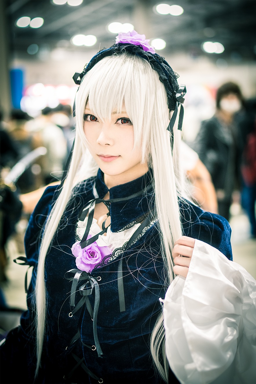 1girl bangs black_dress blurry blurry_background blurry_foreground bokeh closed_mouth depth_of_field dress flower hairband long_hair long_sleeves looking_at_viewer ribbon rose solo suigintou upper_body white_hair