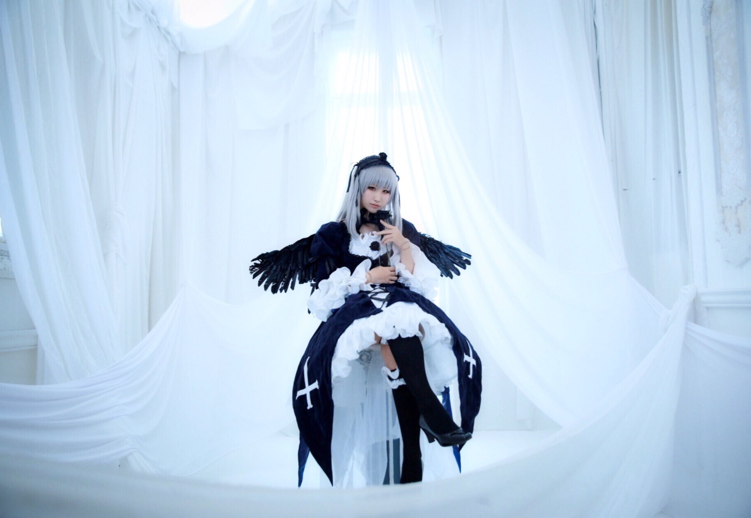 1girl black_wings closed_eyes dress feathered_wings feathers hairband long_hair long_sleeves silver_hair solo standing suigintou thighhighs wings