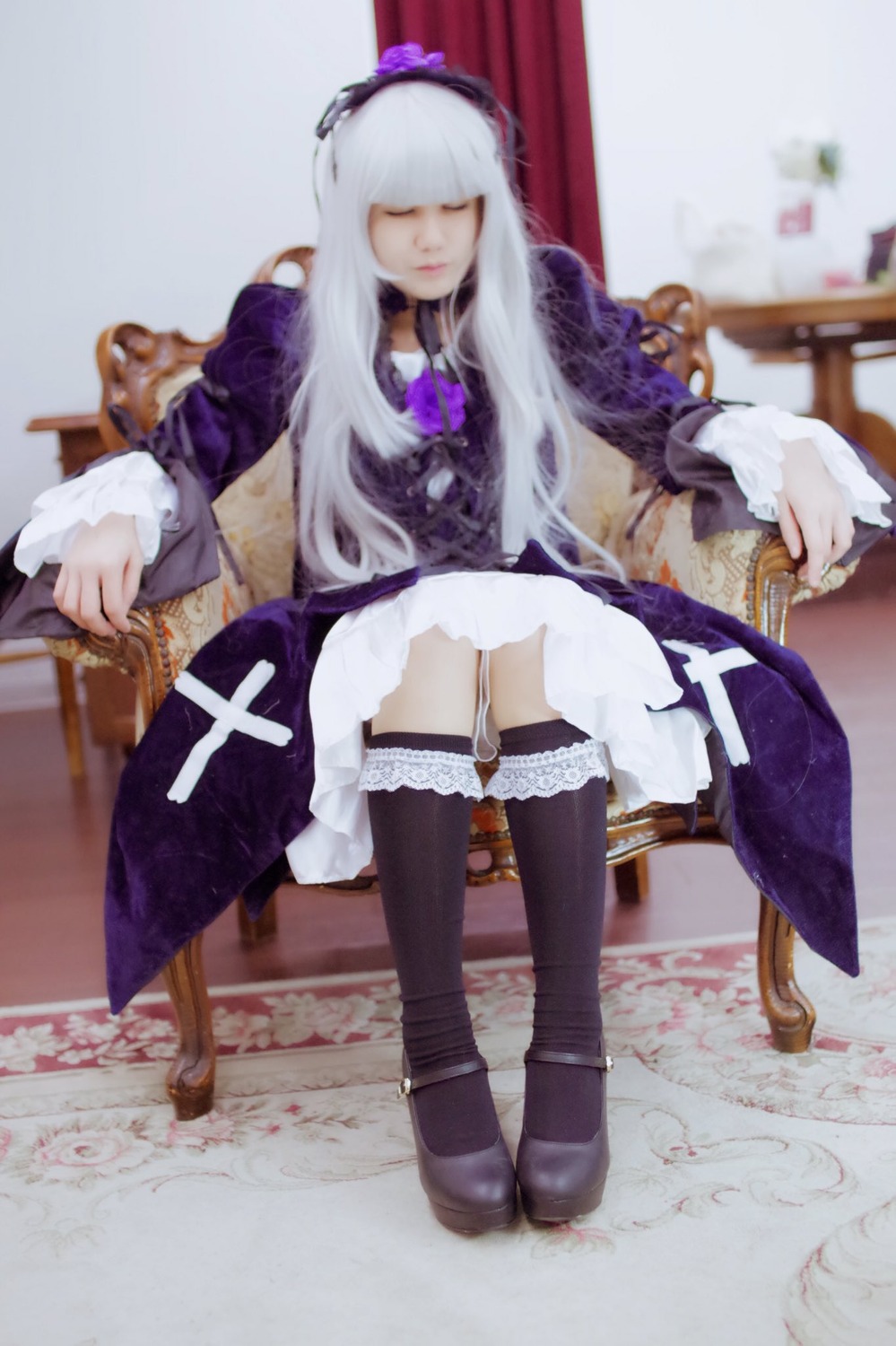 1girl blurry chair choker closed_eyes depth_of_field dress frills long_hair silver_hair sitting solo suigintou thighhighs