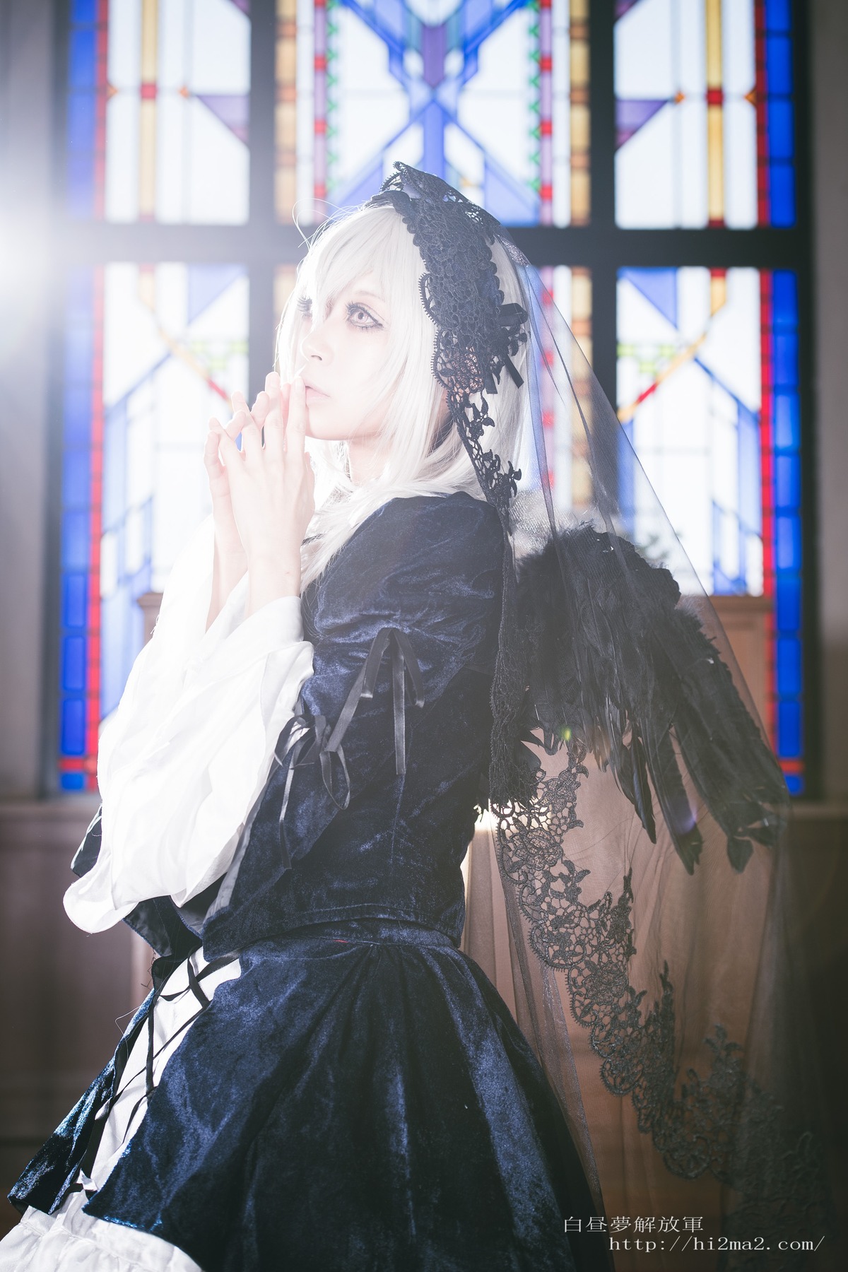 1girl black_dress blue_eyes blurry blurry_background blurry_foreground depth_of_field dress feathered_wings long_sleeves nail_polish photo solo stained_glass standing suigintou veil white_hair white_wings wings